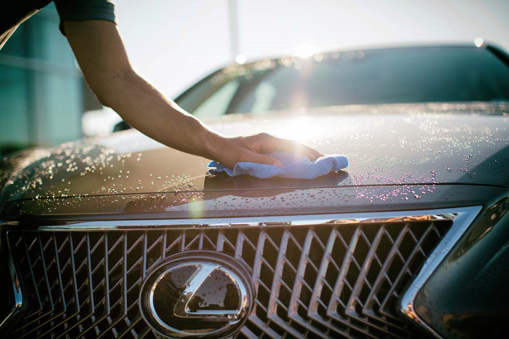 washing the hood of a Lexus car
