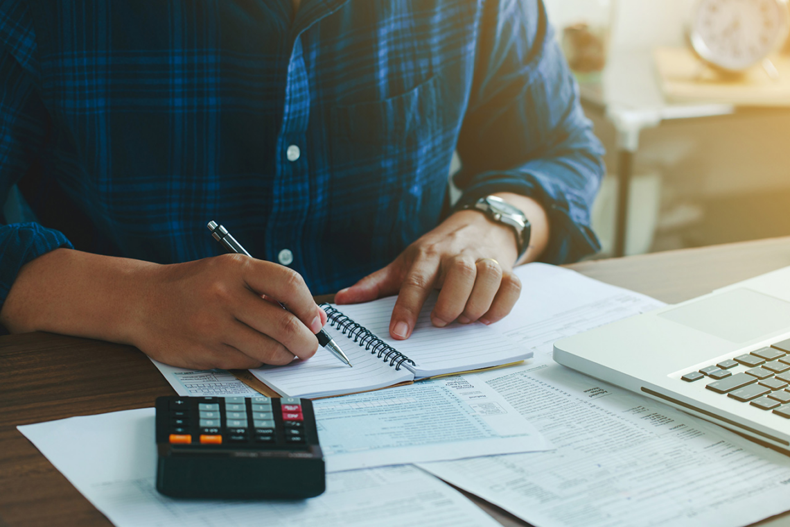 man filling out loan paperwork