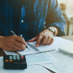 man filling out loan paperwork