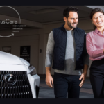 Lexus dealer with customer and white SUV